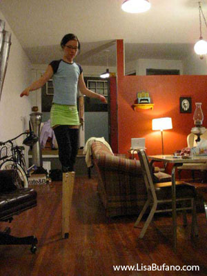 Lisa wearing an early prototype of the stilts made from wooden 2 by 4s